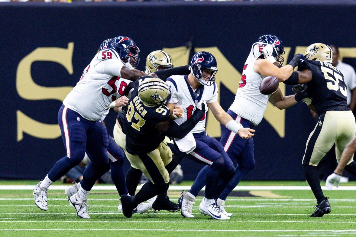 Aug 27, 2023; Houston Texans quarterback Davis Mills (10) is sacked by New Orleans Saints defensive end Malcolm Roach (97), who forces a fumble on the play. Mandatory Credit: Stephen Lew-USA TODAY Sports